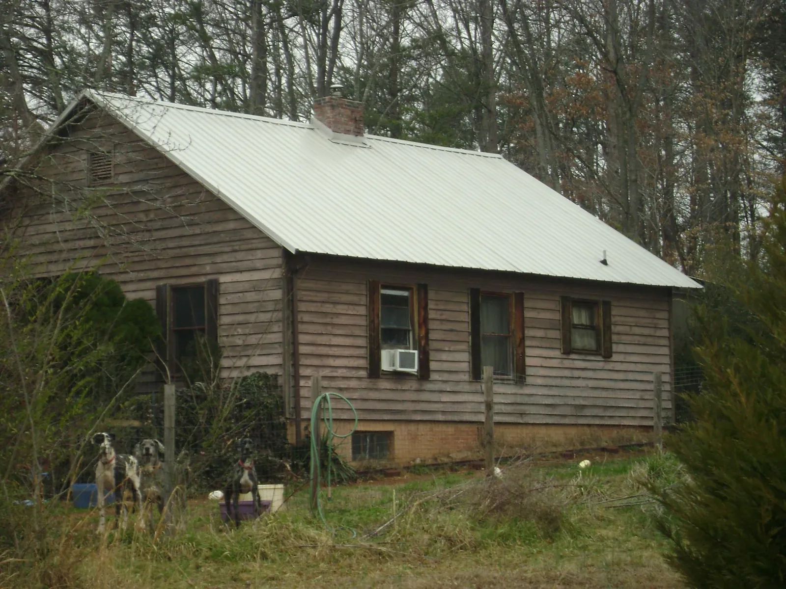 White metal roof on an old wood sided farmhouse, from a Metal Roof Installation job in Eastlake Weir